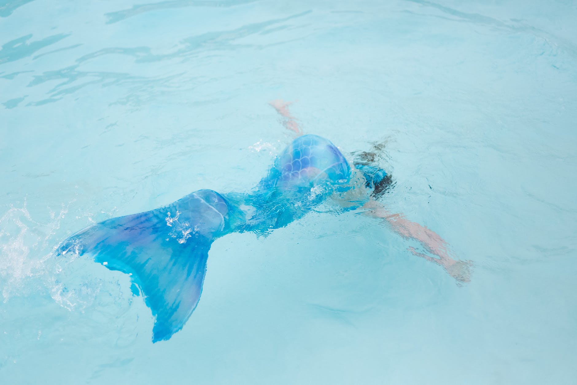photo of woman with blue mermaid tail